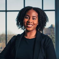 Amy Nkrumah standing on staircase in CASL Atrium